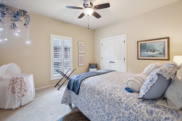 carpeted bedroom featuring ceiling fan and a closet