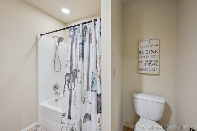 bathroom with shower / bath combo and toilet