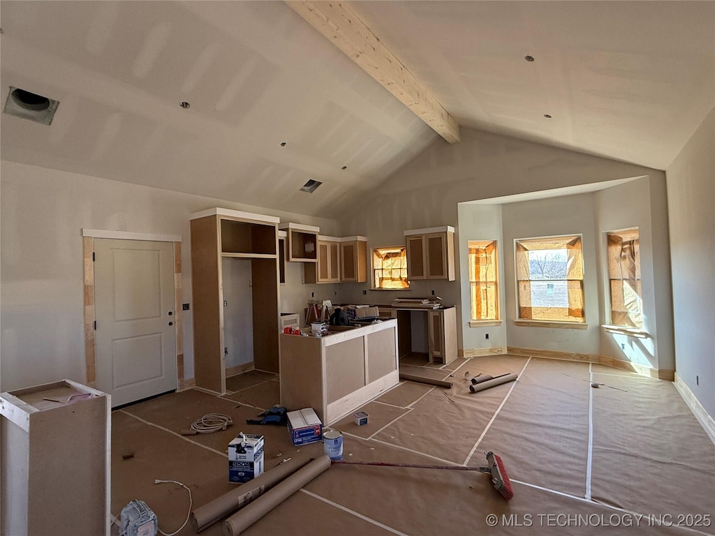 kitchen with high vaulted ceiling and beamed ceiling