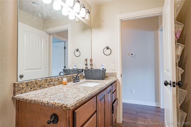 bathroom with vanity and hardwood / wood-style floors