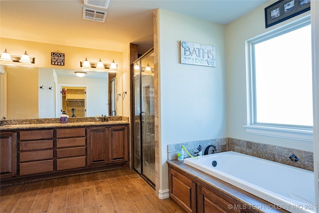 bathroom featuring vanity, wood-type flooring, and independent shower and bath