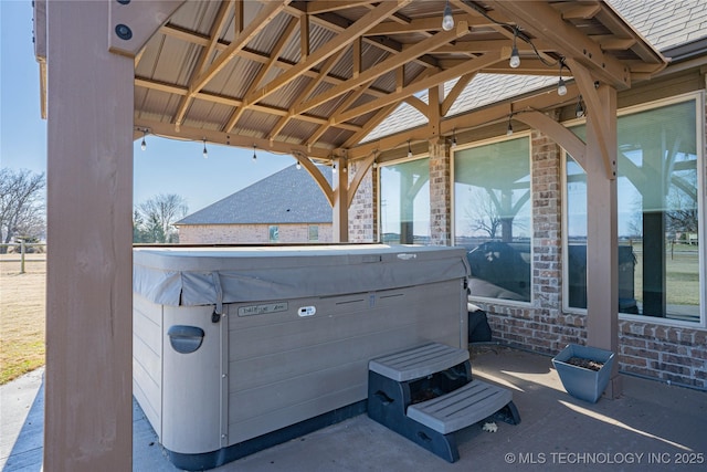 view of patio / terrace with a gazebo and a hot tub