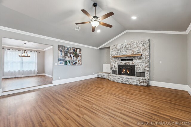 unfurnished living room with crown molding, vaulted ceiling, hardwood / wood-style floors, and a fireplace