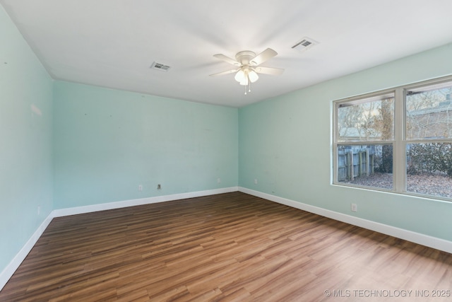 spare room with wood-type flooring and ceiling fan