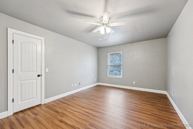 spare room featuring hardwood / wood-style flooring and ceiling fan