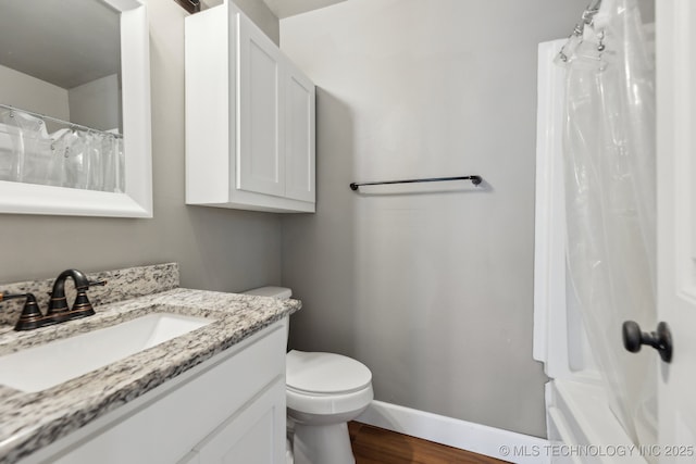 bathroom with vanity, toilet, and wood-type flooring