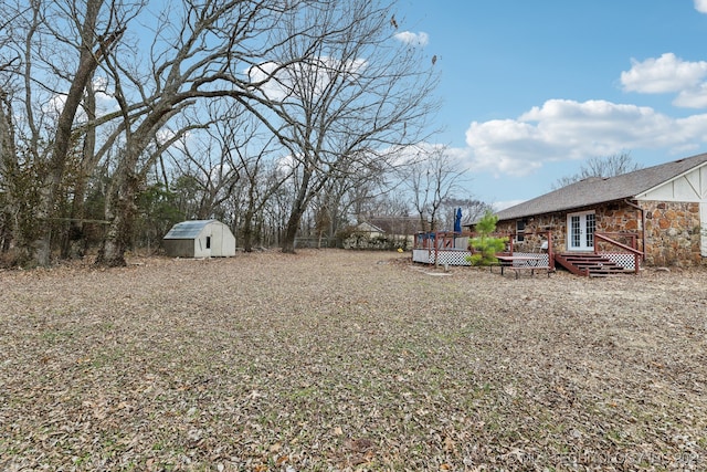 view of yard with a deck and a shed