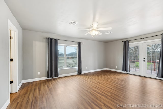 unfurnished room featuring hardwood / wood-style flooring, french doors, and ceiling fan