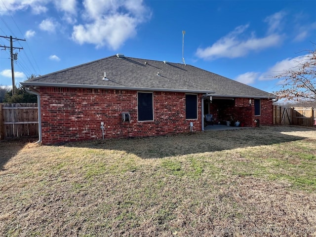 back of house with a lawn