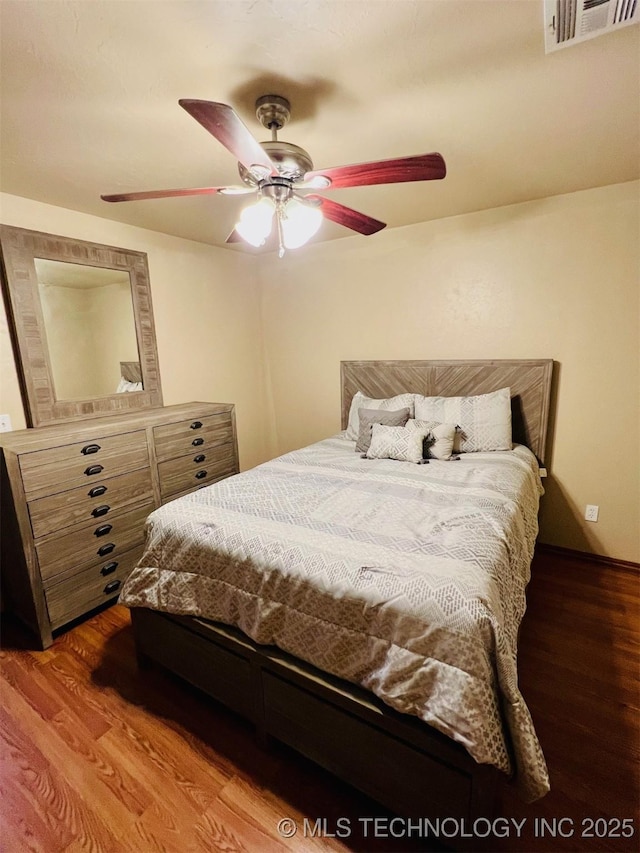 bedroom with hardwood / wood-style flooring and ceiling fan