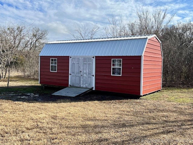 view of outbuilding featuring a yard