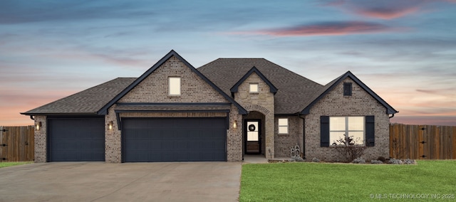 view of front facade featuring a garage and a lawn