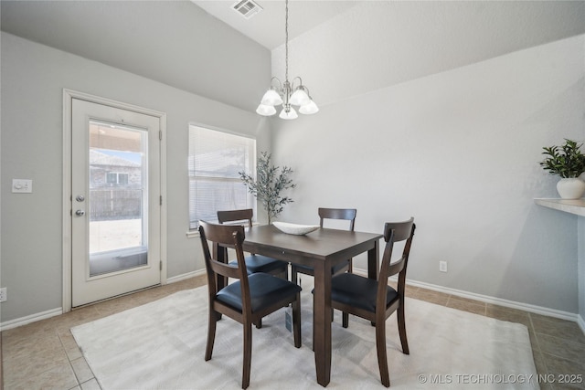 dining room featuring light tile patterned flooring and a notable chandelier