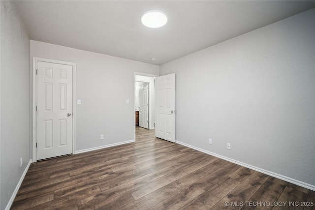 unfurnished bedroom with dark wood-type flooring