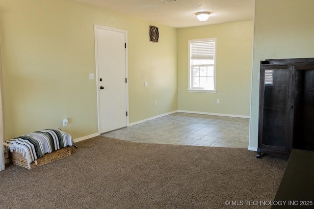 carpeted spare room featuring a textured ceiling