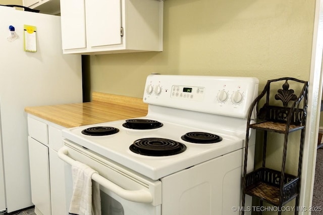 kitchen with white cabinetry and white appliances