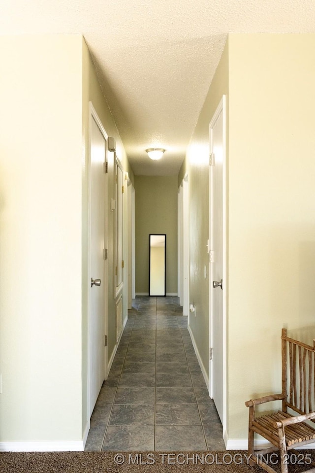 hall featuring a textured ceiling