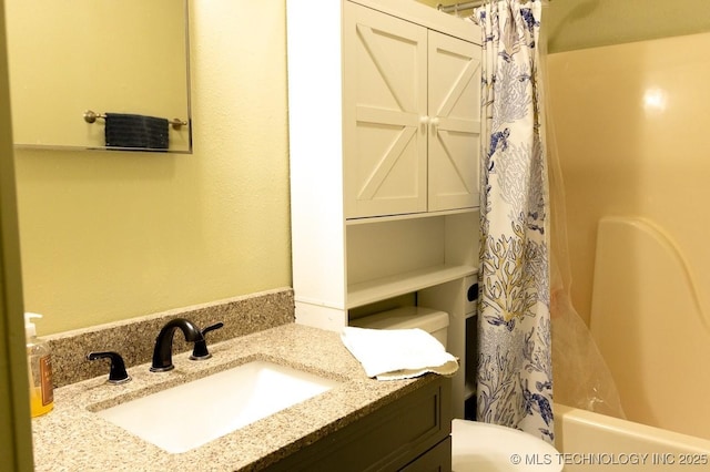 full bathroom featuring vanity, shower / tub combo with curtain, and toilet