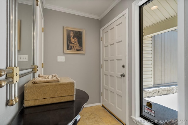 entryway featuring crown molding and light tile patterned floors