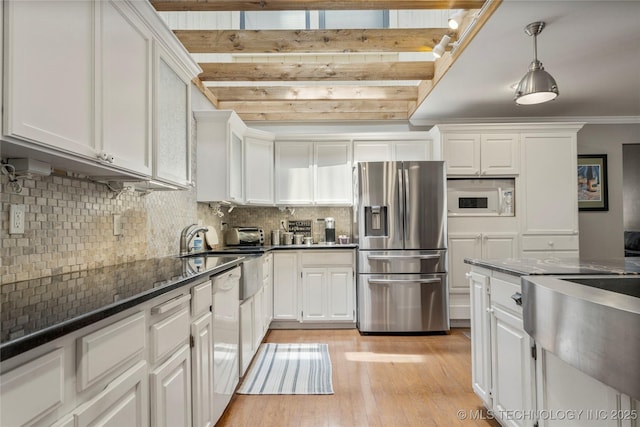 kitchen with light hardwood / wood-style flooring, pendant lighting, white appliances, dark stone counters, and white cabinets