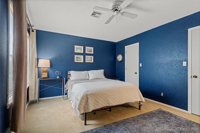 bedroom featuring ceiling fan and light colored carpet