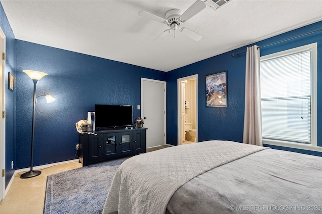 bedroom featuring carpet floors, connected bathroom, and ceiling fan