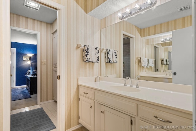 bathroom featuring tile patterned flooring and vanity