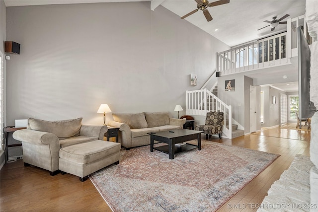 living room with beamed ceiling, ceiling fan, high vaulted ceiling, and hardwood / wood-style floors