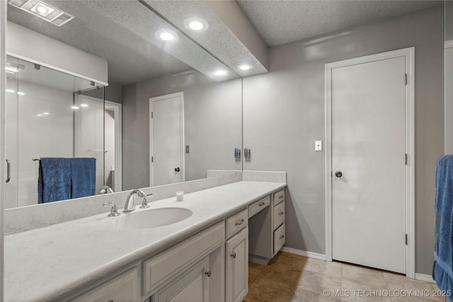 bathroom with vanity, tile patterned flooring, and a textured ceiling