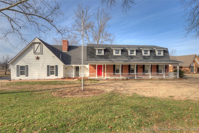 view of front of home with a front yard and covered porch