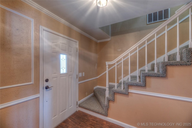 entrance foyer featuring ornamental molding and wood-type flooring