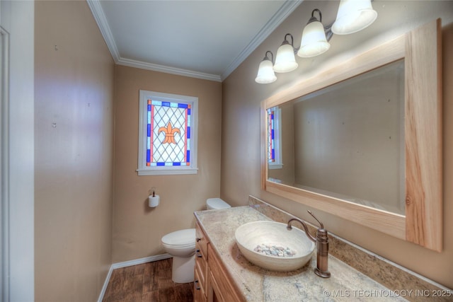 bathroom with crown molding, hardwood / wood-style floors, vanity, and toilet