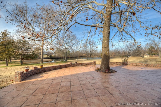 view of patio featuring a water view