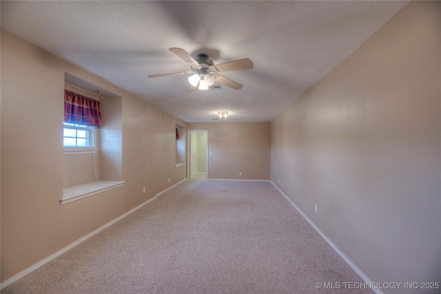 carpeted spare room featuring a textured ceiling and ceiling fan