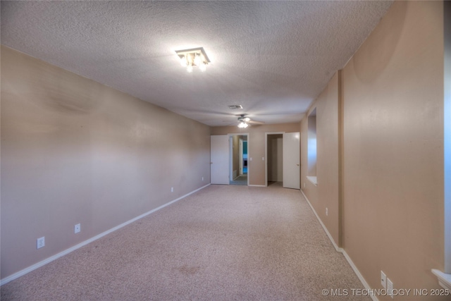 spare room with light carpet, a textured ceiling, and ceiling fan