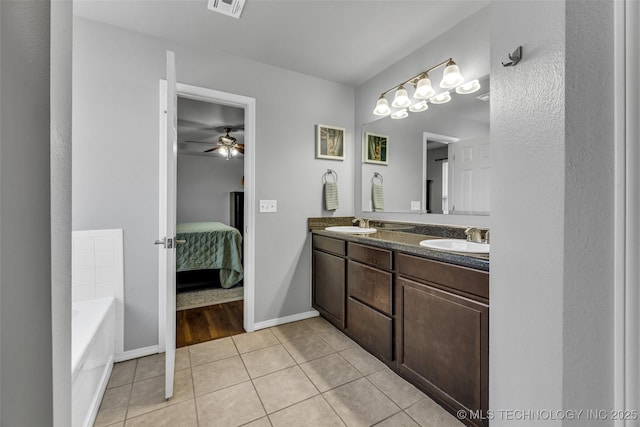 bathroom featuring tile patterned flooring, a tub to relax in, vanity, and ceiling fan