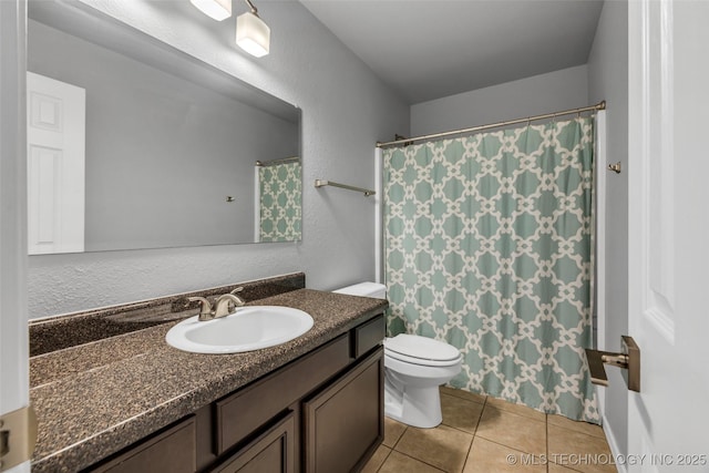 bathroom featuring vanity, tile patterned floors, and toilet