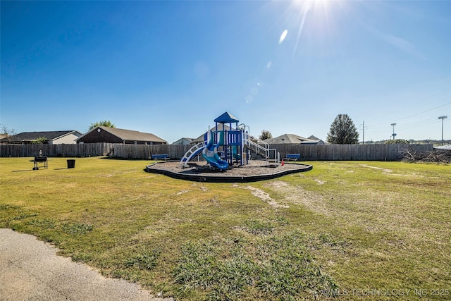 view of playground with a lawn