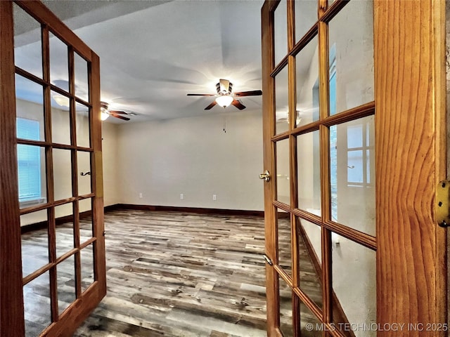 empty room featuring hardwood / wood-style flooring, french doors, and ceiling fan