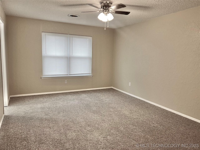 carpeted spare room featuring ceiling fan and a textured ceiling