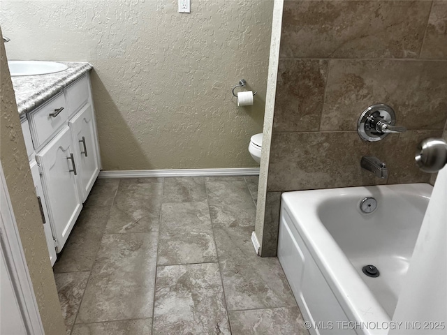 bathroom featuring vanity, toilet, and a bathing tub