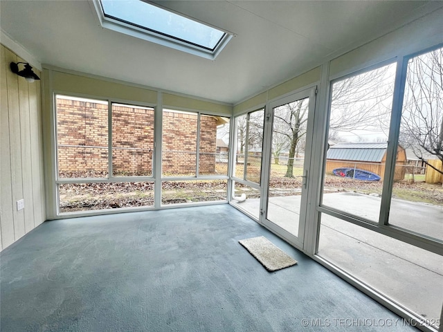 unfurnished sunroom featuring plenty of natural light and a skylight