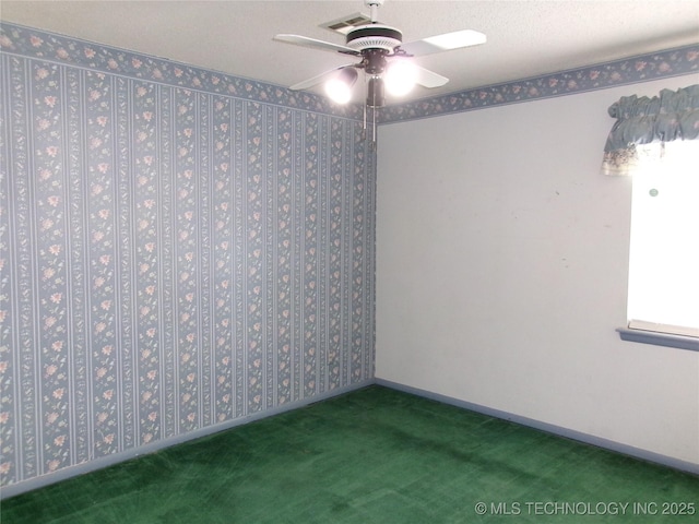 carpeted spare room featuring visible vents, ceiling fan, a textured ceiling, and baseboards