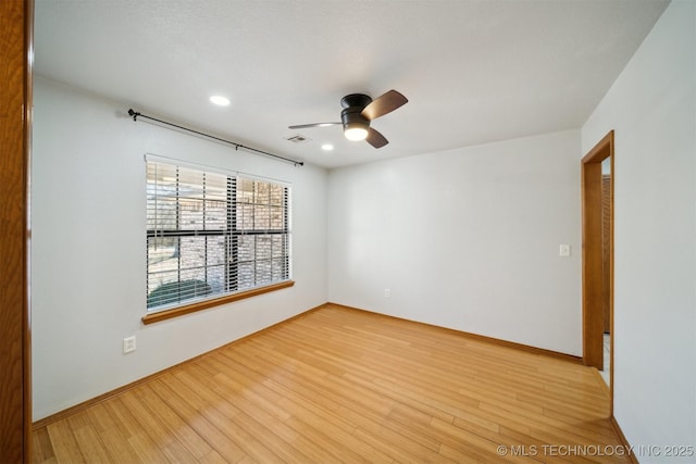 unfurnished room with ceiling fan and light hardwood / wood-style floors