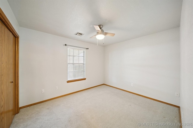 unfurnished bedroom featuring a closet, ceiling fan, and carpet