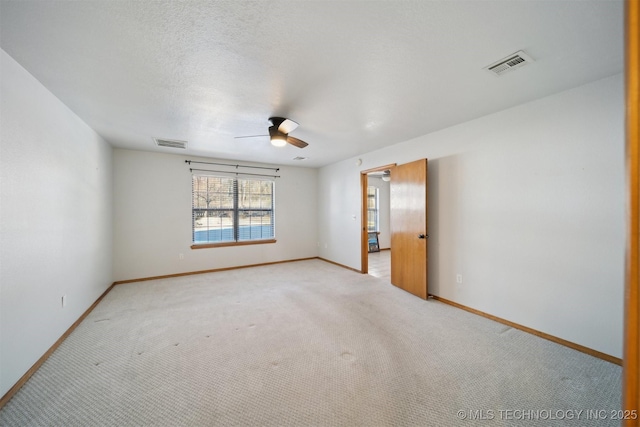 unfurnished room with light carpet, a textured ceiling, and ceiling fan