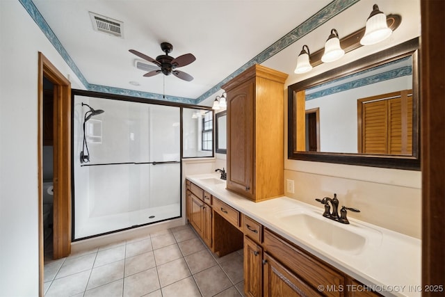 bathroom featuring ceiling fan, tile patterned floors, vanity, and an enclosed shower