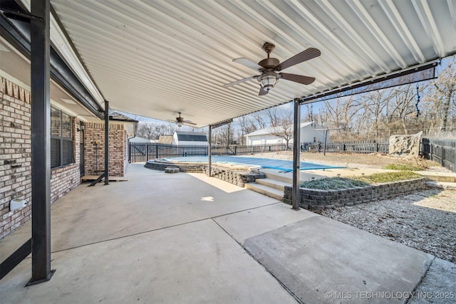 view of patio with a covered pool and ceiling fan