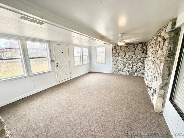 empty room with ceiling fan and carpet floors