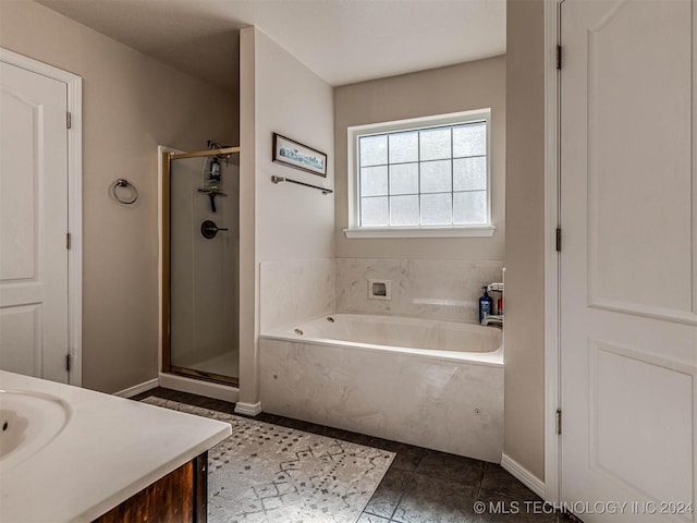 bathroom featuring tile patterned flooring, vanity, and separate shower and tub